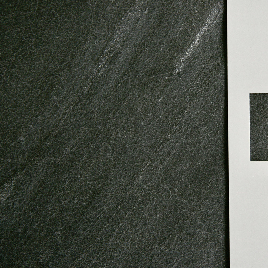 D Black is like Nero [ Black} with a very obvious diagonal "grain" in the stone